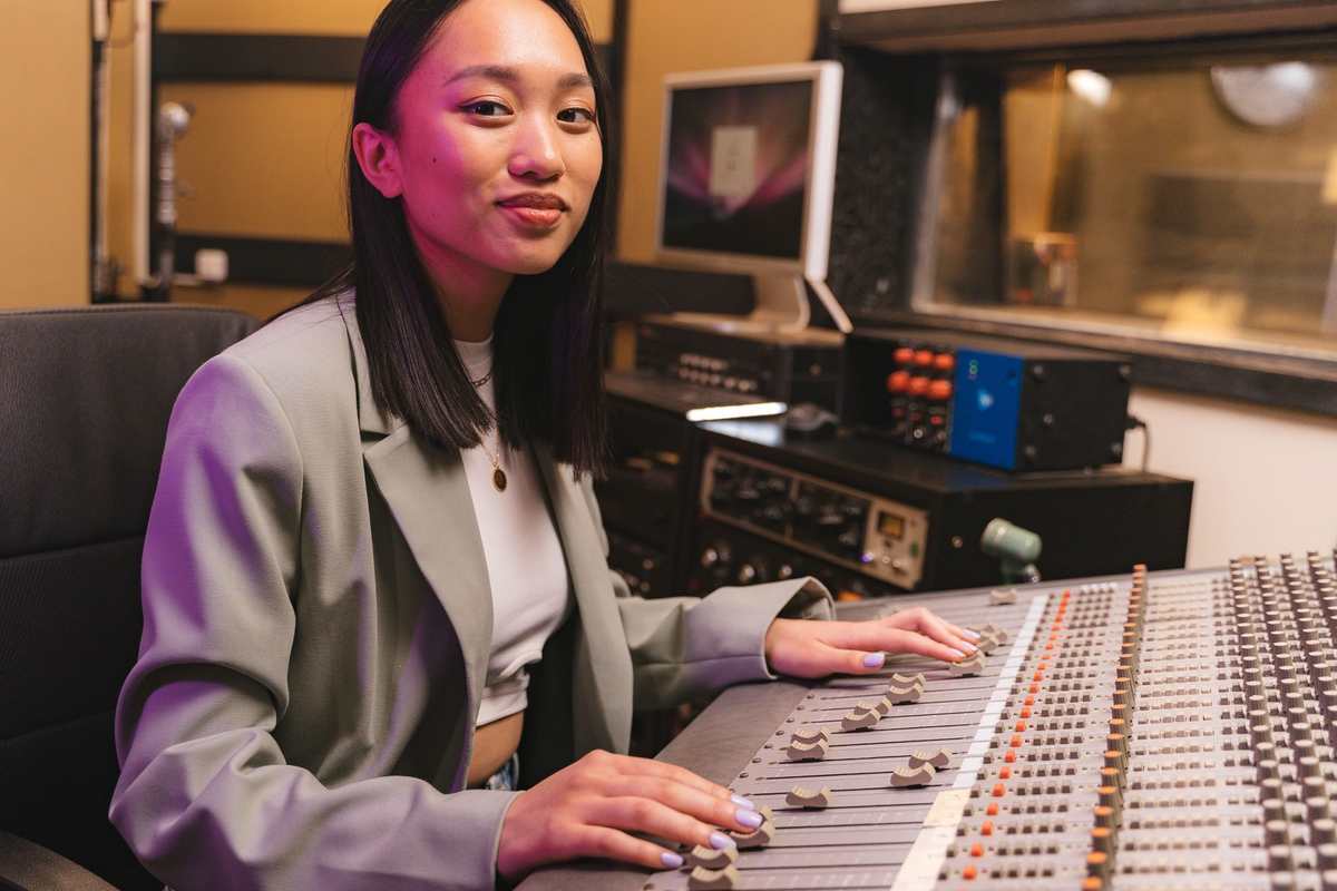 A producer at a mixing console in a recording studio